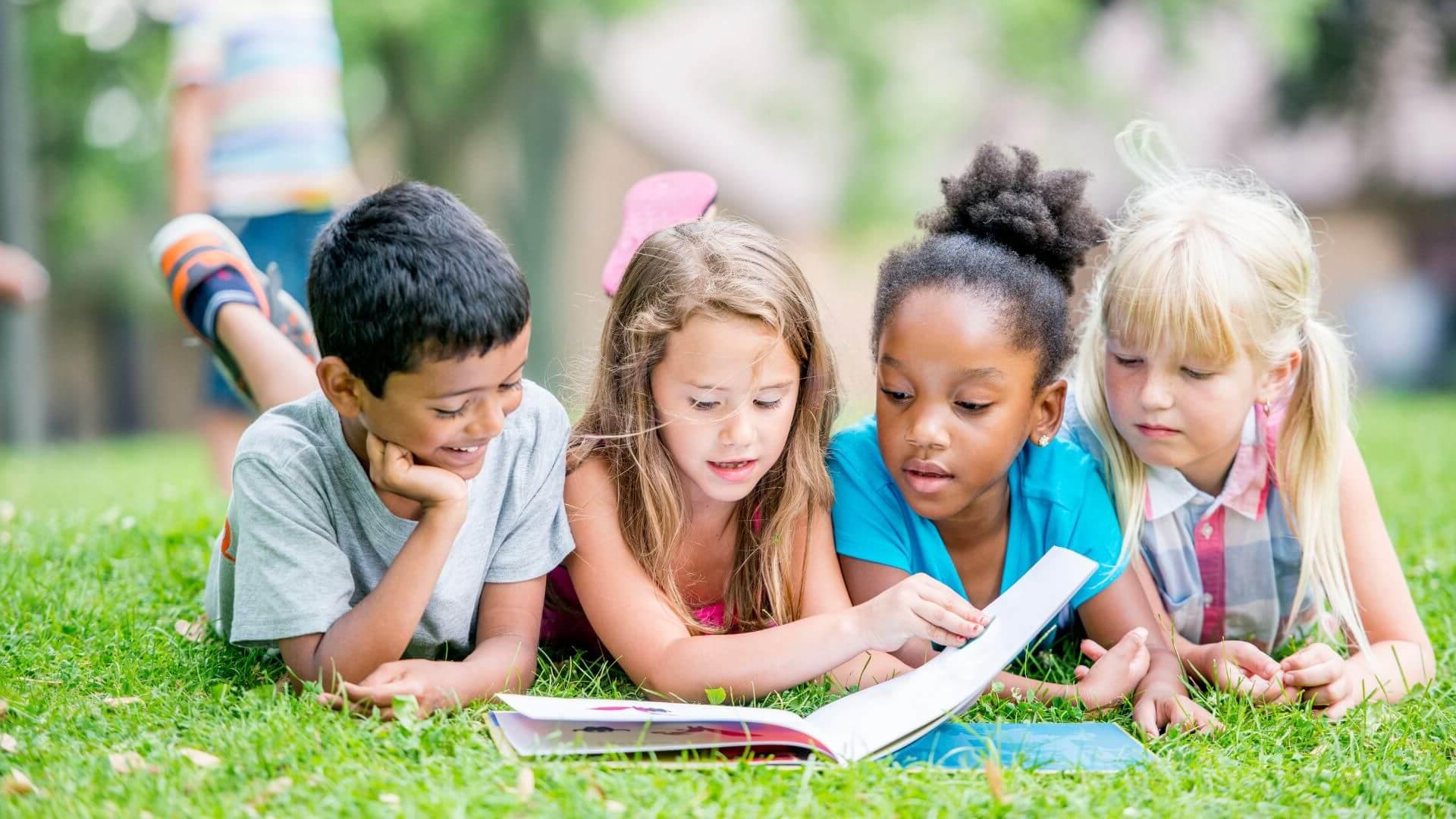 kids reading in the grass